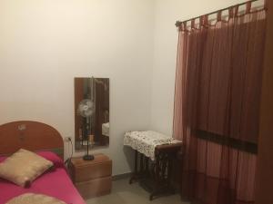 a bedroom with a bed and a table and a mirror at Casa Angeles in Santa Cruz de la Palma