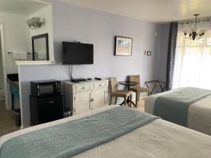 Postel nebo postele na pokoji v ubytování La Kris Inn