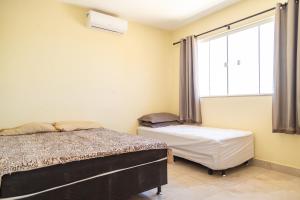 Ένα ή περισσότερα κρεβάτια σε δωμάτιο στο Casa com Piscina Armação de Búzios +27 φωτογραφίες