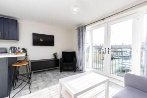 a living room with a table and a large window at Avery House 1 - One Bedroom with Outdoor Terrace in Darlington