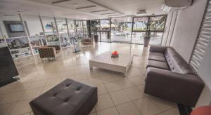 a living room with a couch and a coffee table at Imperial Suites in João Pessoa