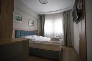 A bed or beds in a room at AquaSun Family Hotel