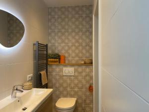 a bathroom with a toilet and a sink at Northgo apartment in Noordwijk