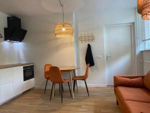 een keuken en eetkamer met een tafel en stoelen bij Northgo apartment in Noordwijk