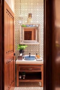 a bathroom with a sink and a mirror at Hotel Casamada in San Miguel de Allende