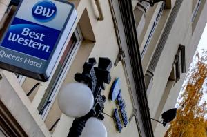 a sign for a best western hotel on the side of a building at Best Western Queens Hotel in Perth