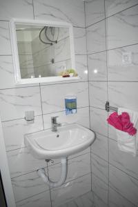 a white bathroom with a sink and a mirror at Šepački Most, Banja Koviljača, Loznica in Loznica