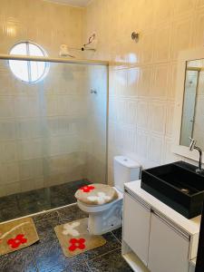 une salle de bains avec toilettes et lavabo dans l'établissement Chácara Cateto, à Socorro