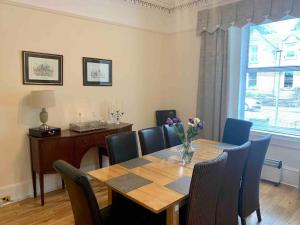 a dining room with a table and chairs and a desk at Allerton - Victorian Character Home in Stirling in Stirling