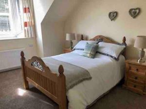 a bedroom with a large bed and a window at Allerton - Victorian Character Home in Stirling in Stirling