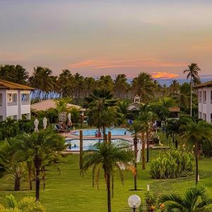a resort with a pool and palm trees in a park at Tree Bies Resort in Entre Rios