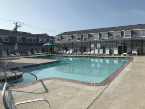 a large swimming pool with chairs and a building at Royal Palm Court B5 in Ocean City