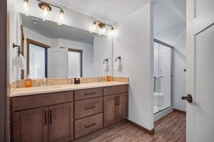 a bathroom with a sink and a large mirror at Elk Grove Getaway in Ponderay +27 photos