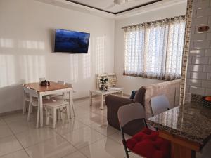 a living room with a table and a couch at KSL Residence in Boca Chica