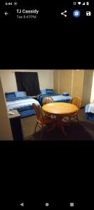 a table and chairs in a room with beds at Marinette Inn in Marinette