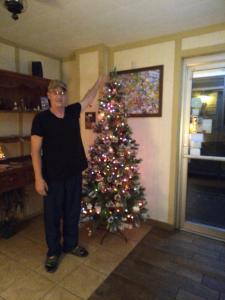 a man standing next to a christmas tree at Marinette Inn in Marinette