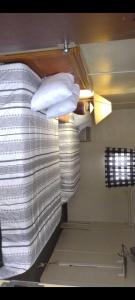 a bed with white pillows on it in a room at Marinette Inn in Marinette