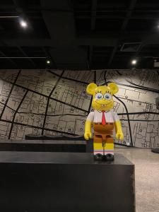 a yellow teddy bear wearing a suit and tie at White Palace Bangkok in Bangkok