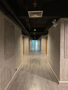an empty hallway in an office building with wood floors at White Palace Bangkok in Bangkok