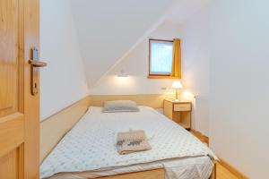 A bed or beds in a room at Alpine Retreat Gaja Kranjska Gora - Happy Rentals