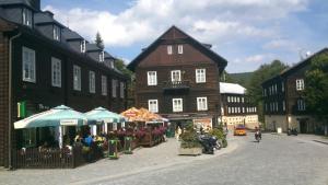 a town with a market in the middle of a street at Horské apartmány Jeseníky in Malá Morávka