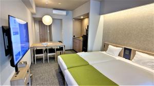 A bed or beds in a room at MONday Apart Premium UENO