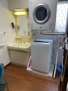 a small bathroom with a washing machine and a sink at Tiz wan 津名あわじ in Awaji +30 photos