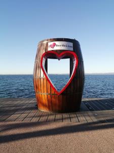 a heart shaped object sitting on a dock near the water at Casa Nicole in Bardolino