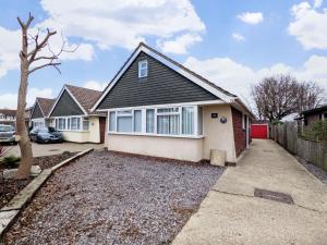 a house with a car parked in a driveway at Ems Cottage - Emsworth in Emsworth