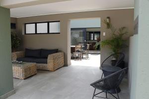 a living room with a couch and chairs at The Guesthouse 6 on Vrede in Johannesburg