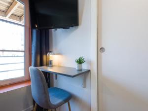 a room with a desk and a chair and a window at Hyper centre chambre au calme in Lille