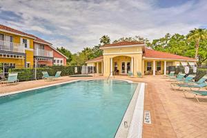 a swimming pool in front of a house at Family-Friendly Lake Berkeley Resorts Home! in Kissimmee