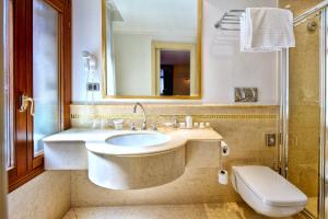 a bathroom with a sink and a toilet and a mirror at Ca' Princess in Venice