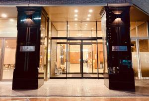 a store front with two large glass doors at Hotel Kanazawa in Kanazawa