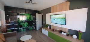 a living room with a television on a wall at Chilia 1 Apartments in Chilia Veche