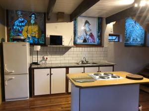 a kitchen with a refrigerator and a counter top at La Chapelle - The Library in Montagu +10 photos