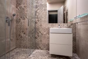 a bathroom with a sink and a shower at Aparthotel Rimska 14 in Prague