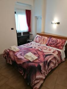 a bedroom with a large bed with two towels on it at Accomodation Verona - City Centre in Verona