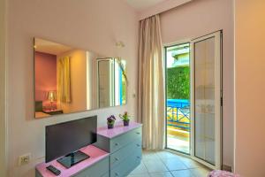 a bathroom with a dresser and a large mirror at BBQ-Balcony-42Mbps-King-Backyard-Full Kitchen-2 in Amoudara Herakliou