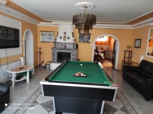 a living room with a pool table in it at Borostyán Nyaralóház Balatonboglár in Balatonboglár