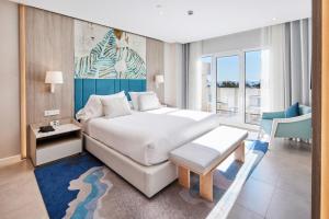 a bedroom with a bed and a table and a chair at Alanda Marbella Hotel & Wellness in Marbella