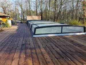 a swimming pool on a wooden deck at Au Bois Flotté in Hourtin