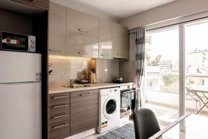 a kitchen with a washing machine and a dishwasher at 7-Athens new morden comfortable-center,metro,private parking in Athens