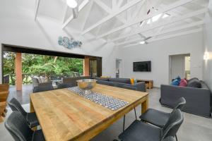 uma sala de estar com uma mesa de madeira e cadeiras em San Lameer Villa 2603 - 4 Bedroom Superior - 8 pax - San Lameer Rental Agency em Southbroom