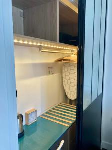 a kitchen with a refrigerator with a counter top at Cannes City B&B in Cannes