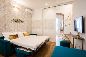 a bedroom with a bed and a blue chair at Design Suite Cinque Terre La Spezia in La Spezia