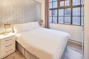 a bedroom with a white bed and a window at Host & Stay - Concert Square in Liverpool