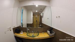 a bathroom with a glass sink and a mirror at Bellini View in Naples
