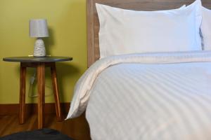 A bed or beds in a room at Pefkofyto Mountain Retreat