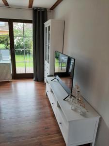a white dresser with a mirror on top of it at Beiboot in Wangerland